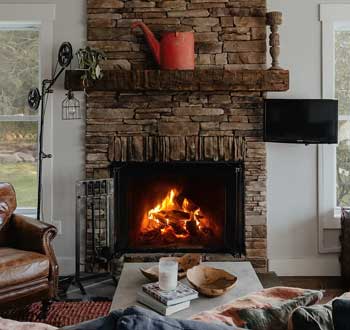Annual Fireplace Maintenance - Photo of a very nice stone fireplace in a home.