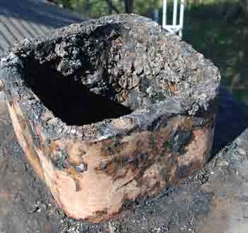Creosote Removal - Photo of a chimney with a heavy creosote buildup.